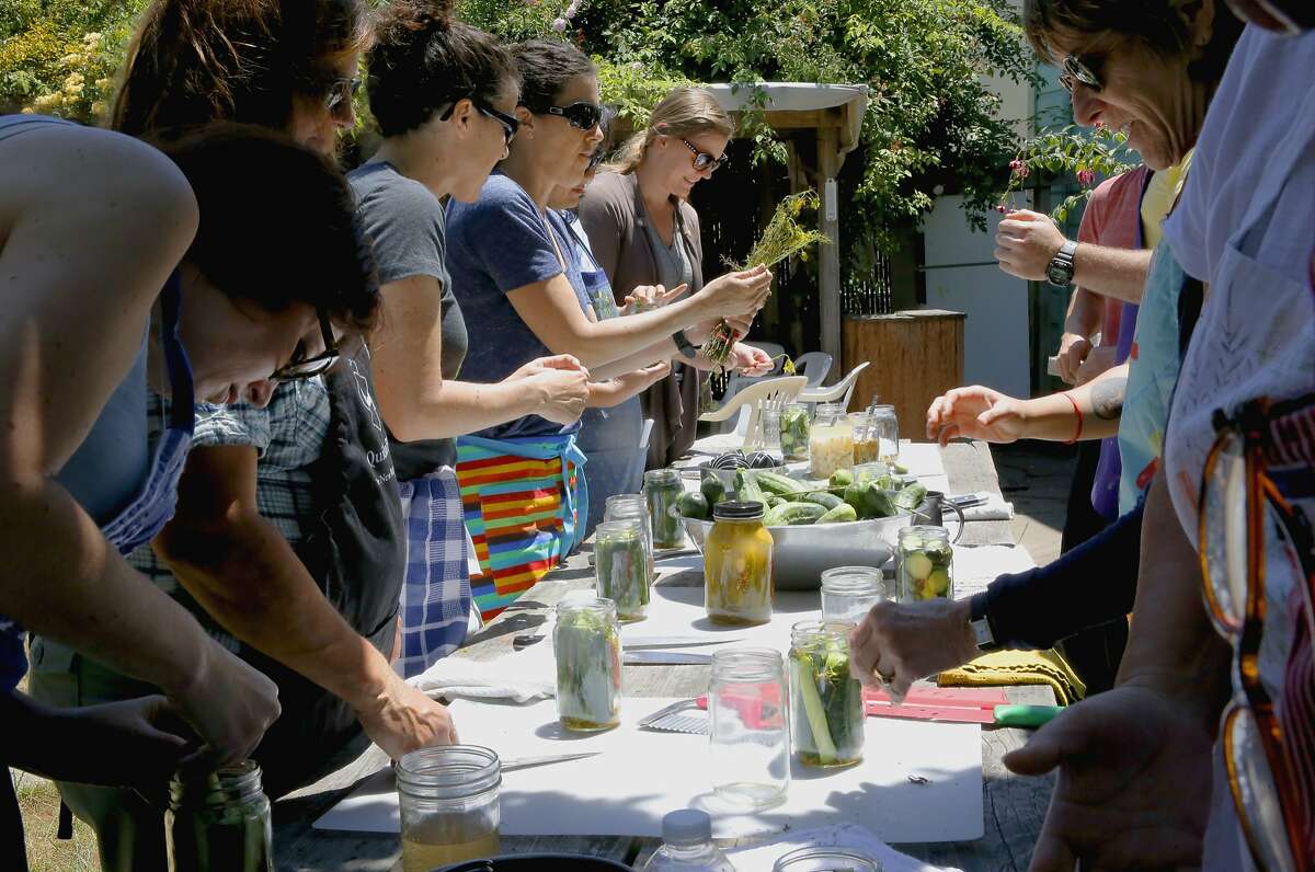Students combine the ingredients as Todd Champagne during the Happy Girl Kitchen Co. pickling workshop, in Oakland, Calif., on Sat. July 11, 2015.