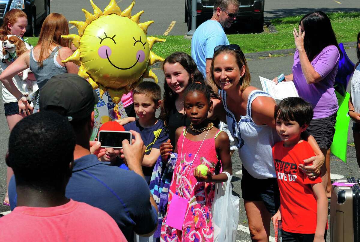 Kids from the Fresh Air Fund program arrive to join their host families at Roger Ludlowe Middle School in Fairfield, Conn., on Saturday July 11, 2015. The Fresh Air Fund program gives city kids a chance to experience the country in summer by staying with a host family.