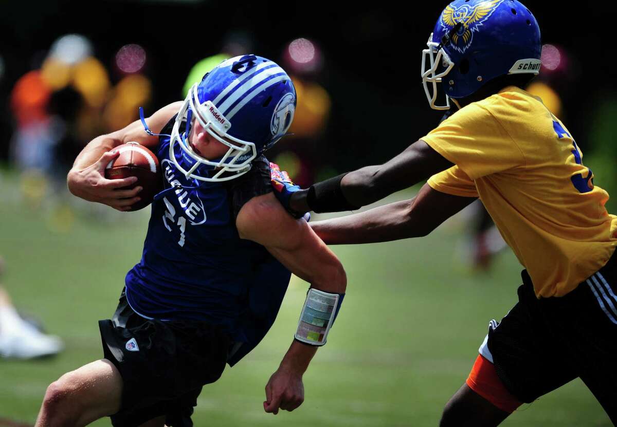 Darien's Shelby Grant receives the ball as Harding High School defends during the annual Grip It and Rip It 7-on-7 passing tournament at New Canaan High School Saturday, July 11, 2015.