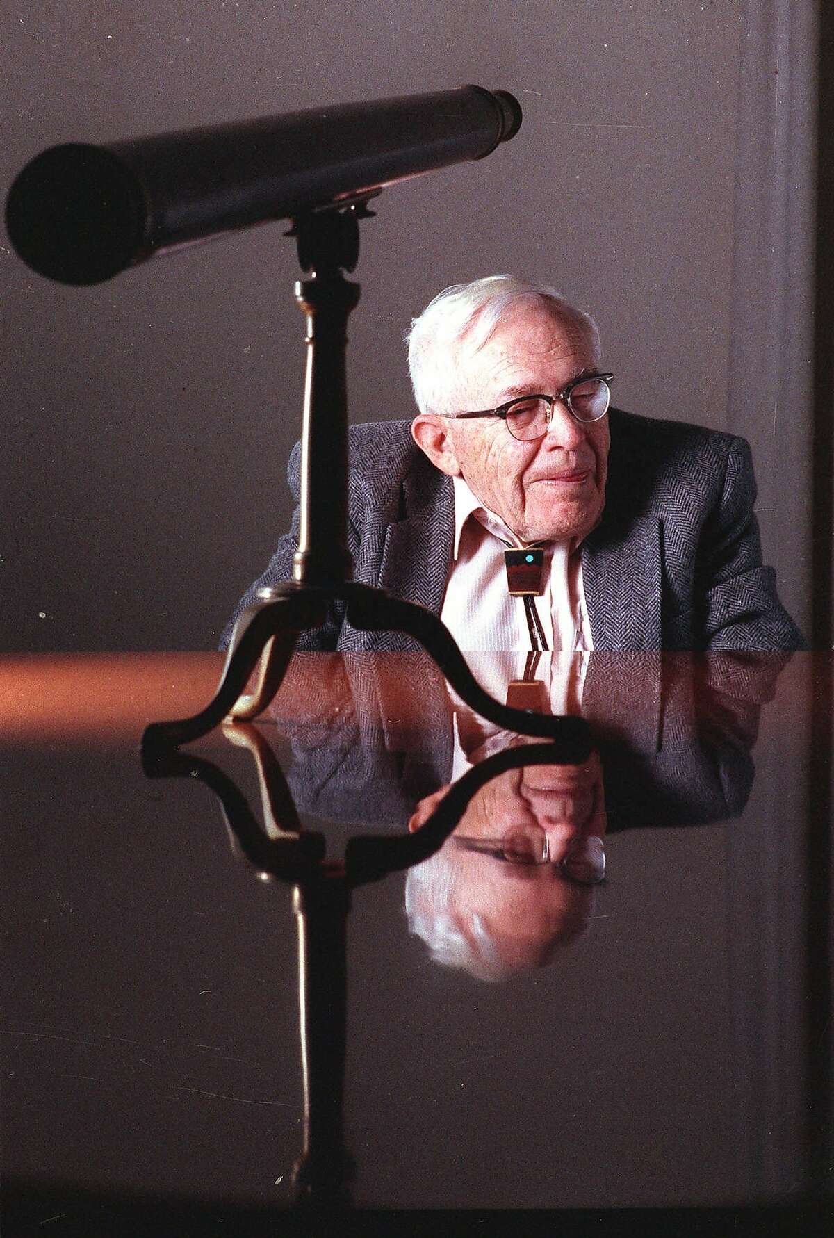 FILE- This 1990 file photo shows Clyde Tombaugh in New York. On Tuesday, July 14, 2015, NASA's New Horizons spacecraft, carrying a small canister with his ashes, is scheduled to pass within 7,800 miles of Pluto which he discovered 85 years ago.