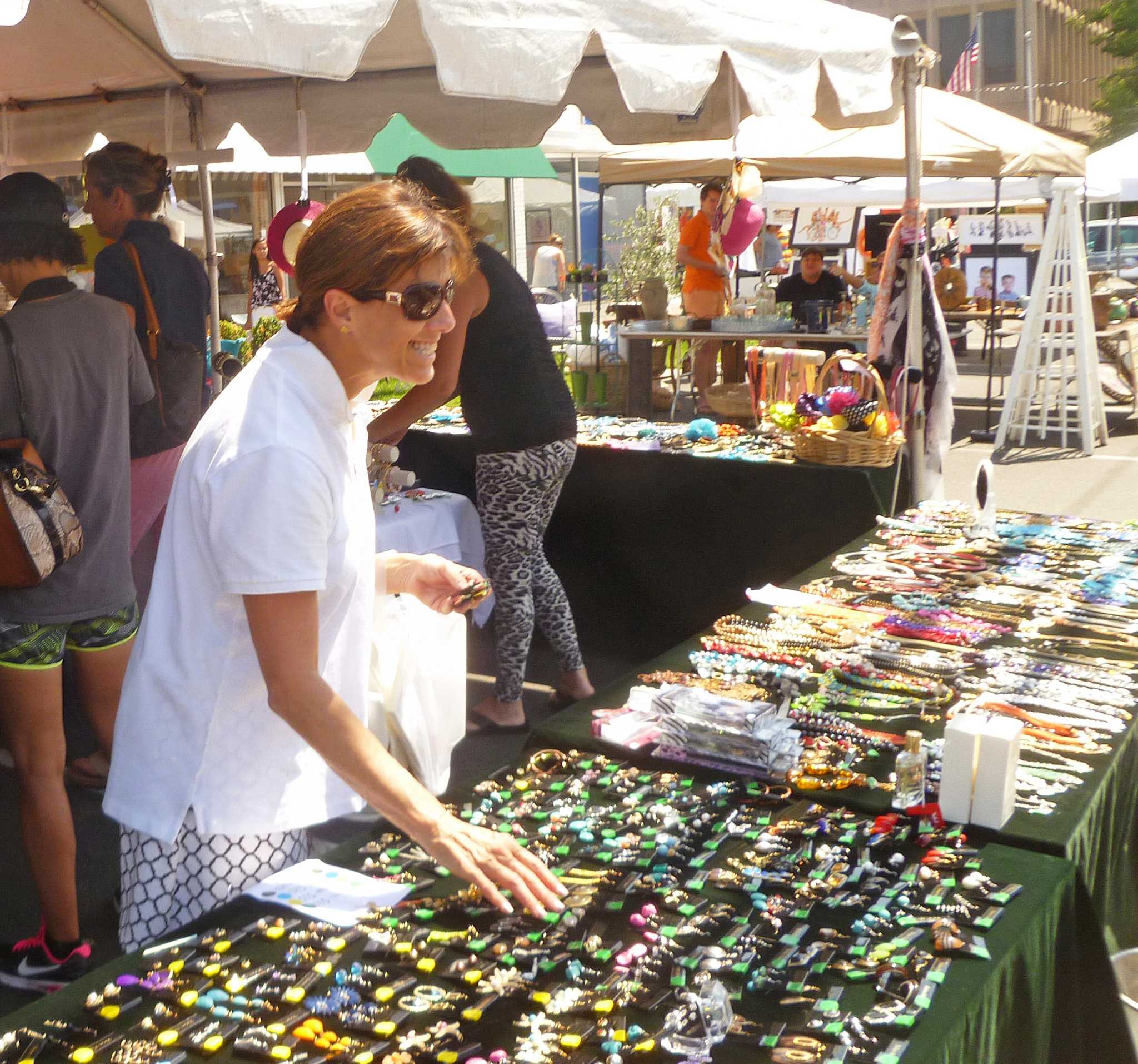 Sidewalk sales bring bustle to sleepy summer streets