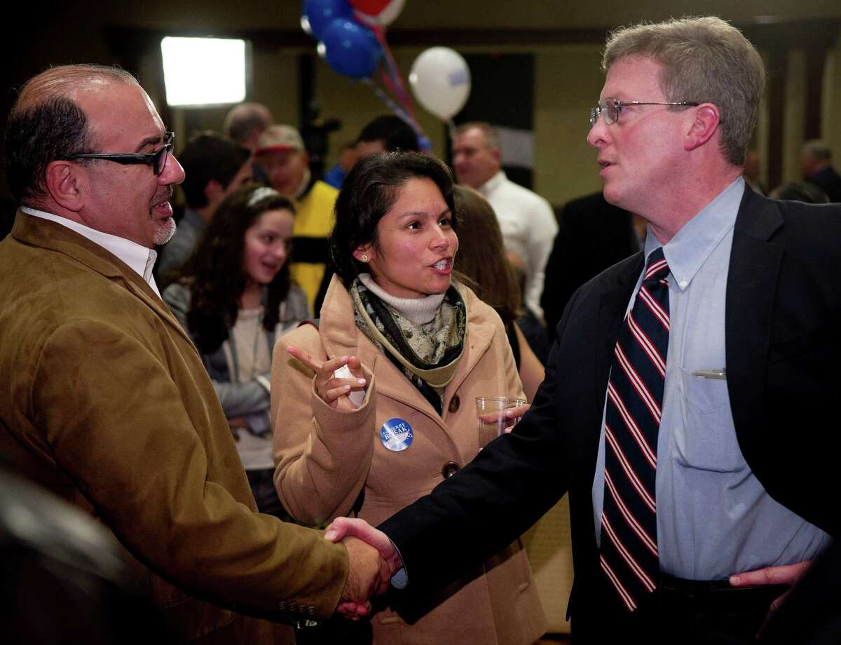 Board of Education member John Leydon, Jr., right, is shown here greeting supporters the night of his re-election to the board in 2013.