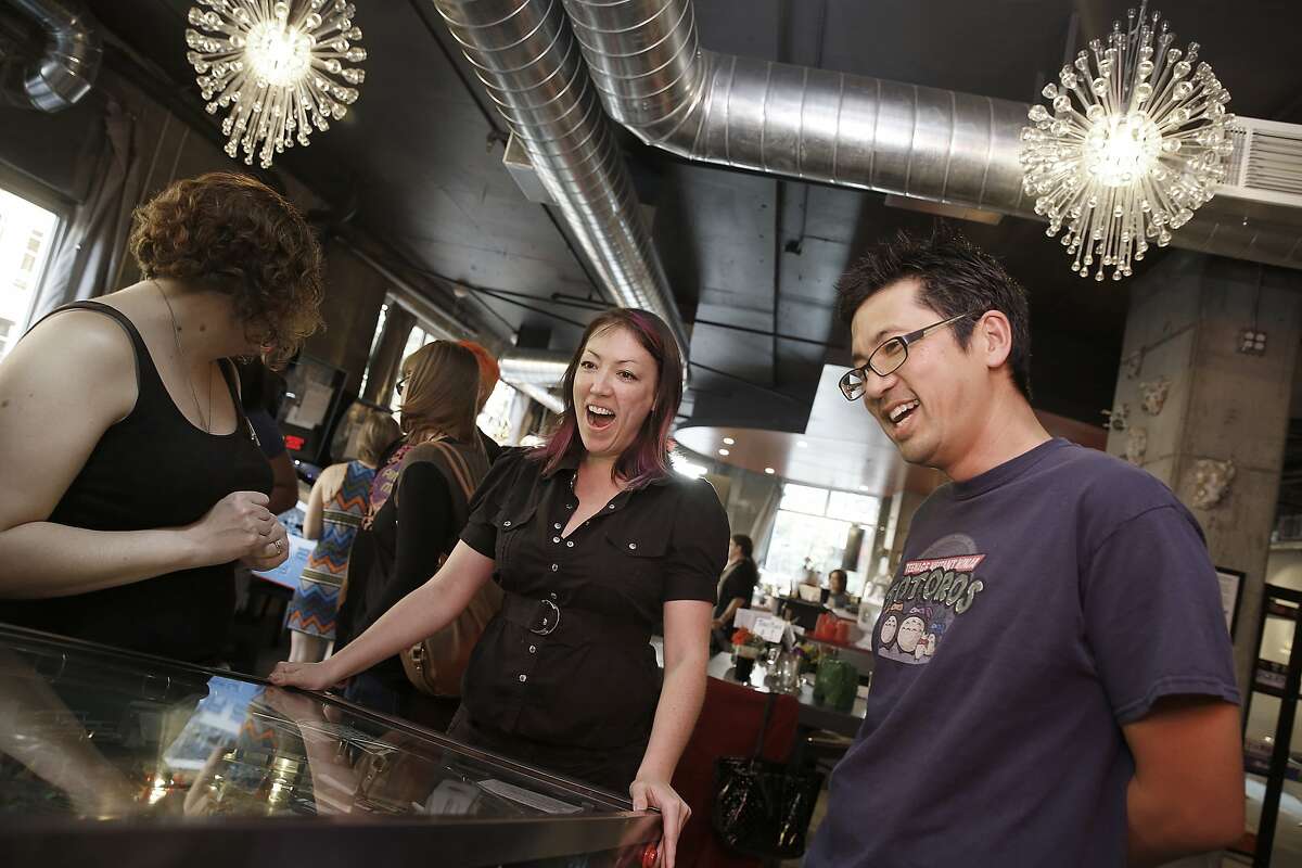Sarah Donovan (left), Kimberly Blum (middle), and David Lee (right) play the Isolinear Flip, a pinball obstacle course, at the Scarlet City Espresso Bar in Emeryville, Calif., on Friday, July 10, 2015.