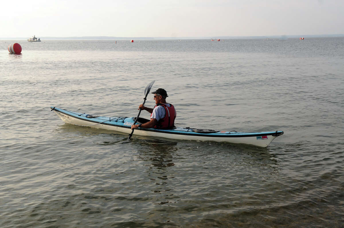 Bob DeAngelo sets out in a kayak during the One Mile Greenwich Point Swim at Tod's Point in Greenwich .