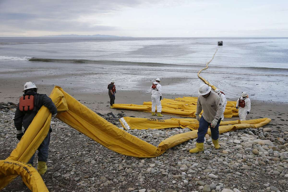 FILE - In this May 21, 2015 file photo, workers prepare an oil containment boom at Refugio State Beach, north of Goleta, Calif. The nation's top pipeline regulator is lagging in meeting congressional requirements imposed several years ago but it is planning to increase staff for safety inspections, its interim director says. The federal Pipeline and Hazardous Materials Safety Administration has been facing new questions about its effectiveness after a May 19 break near Santa Barbara created the largest coastal oil spill in California in 25 years.