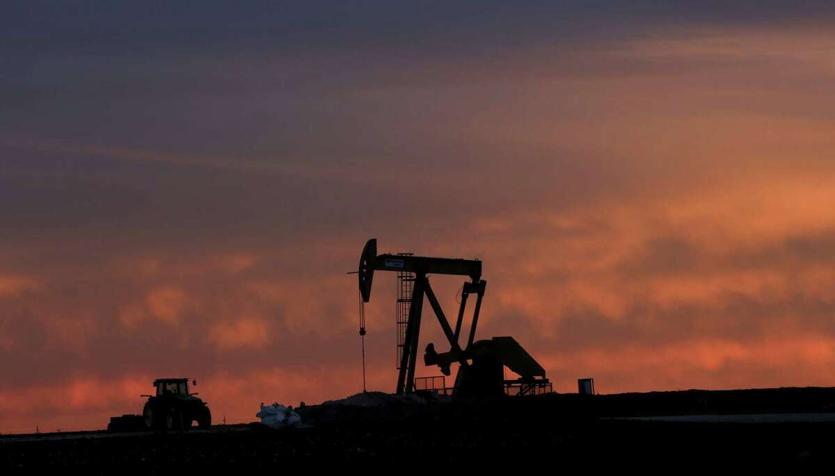 A well pump works at sunset on a farm near Sweetwater, Texas, on Dec. 22, 2014. At the heart of the Cline, a shale formation once thought to hold more oil than Saudi Arabia, Sweetwater is bracing for layoffs and budget cuts, anxious as oil prices fall and its largest investors pull back.