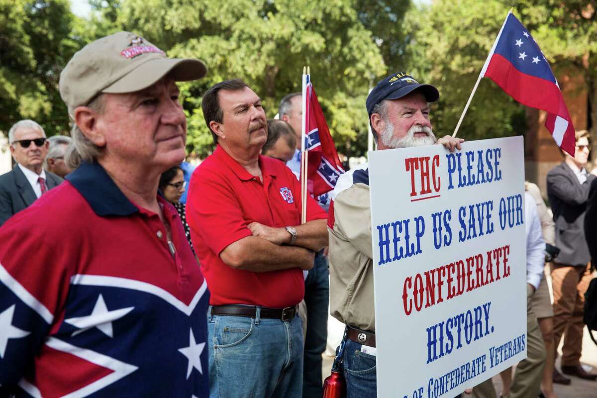 William Smith, Commander of the Sons of Confederate Veterans Camp 153, holds a sign addressed to the Texas Historical Commission during a rededication ceremony for the Bexar County Courthouse after the removal of the 1963 and 1970 Gondeck additions in San Antonio, Texas on July 14, 2015. The renovation restored the Bexar County Courthouse back to its original historic faade.