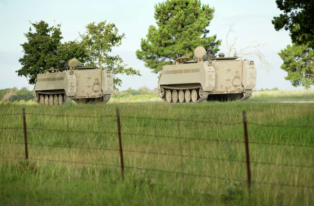 A convoy of National Guard troops moves on Camp Swift, which is also hosting the Operation Jade Helm 15 military exercise, in Bastrop, Texas, on Wednesday July 15, 2015. Jade Helm 15 is summer military training exercise that has aroused alarm among archconservative Texans. (Jay Janner/Austin American-Statesman via AP) AUSTIN CHRONICLE OUT, COMMUNITY IMPACT OUT, INTERNET AND TV MUST CREDIT PHOTOGRAPHER AND STATESMAN.COM, MAGS OUT; MANDATORY CREDIT