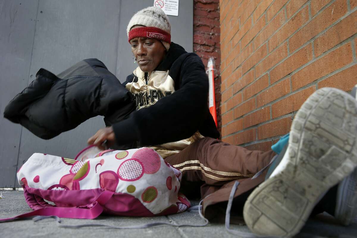 A homeless woman named Listern got her belongings together as she sat on O'Farrell Street near Union Square Wednesday July 15, 2015. Although San Francisco housed over 3000 homeless people in the last two years, the overall homeless count stubbornly remains about the same.