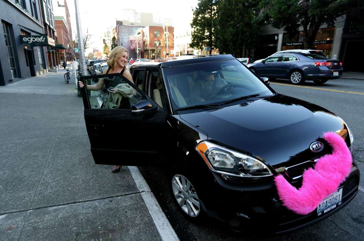 FILE - In this March 12, 2014 file photo, Katie Baranyuk gets out of a car driven by Dara Jenkins, a driver for the ride-sharing service Lyft, after getting a ride to downtown Seattle. The Labor Department on Wednesday, July 15, 2015 issued new guidance intended to help companies answer whether a worker is an employee or a contractor. The issue has taken on greater urgency with the growth of sharing-economy firms such as Lyft, Uber and TaskRabbit, which increasingly rely on independent workers, often for short-term projects. (AP Photo/Ted S. Warren, File)