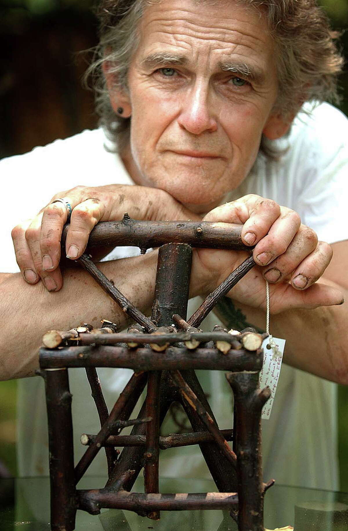Paul Weinman and one of his miniature chairs that he made, Monday, June 27, 2005, in Albany, N.Y. (Steve Jacobs/Times Union)
