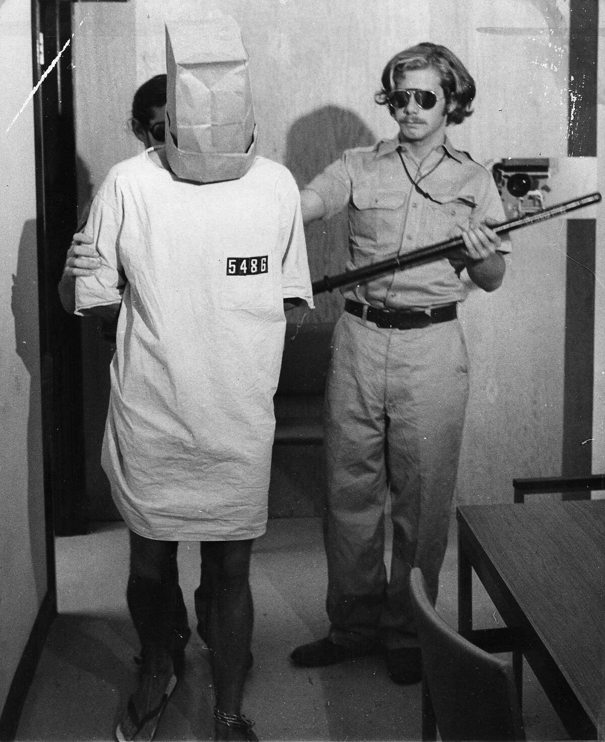 Prisoner with guard John Loftus, involved in the Stanford Prison Experiment.