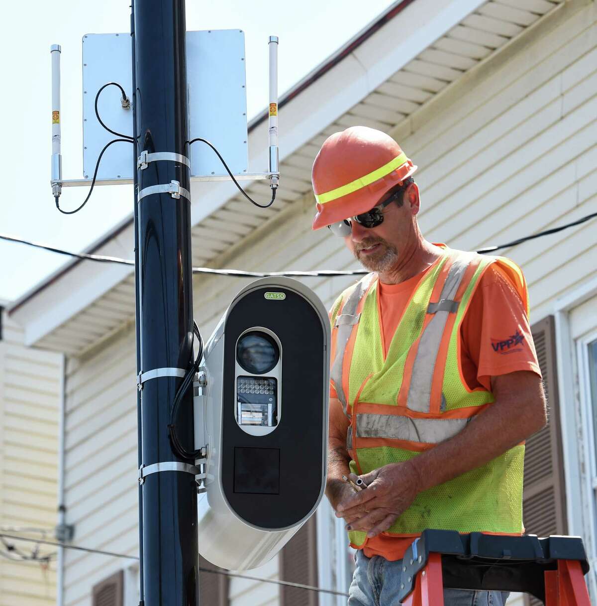 Jeff Smith of the Stilsing Company puts the finishing touches on a red-light camera that looks in to the intersection of Quail Street and Washington Avenue Thursday afternoon, July 16, 2015, in Albany, N.Y. Two intersections selected to receive red light cameras in the city of Albany will be going live on Monday morning after midnight. (Skip Dickstein/Times Union)