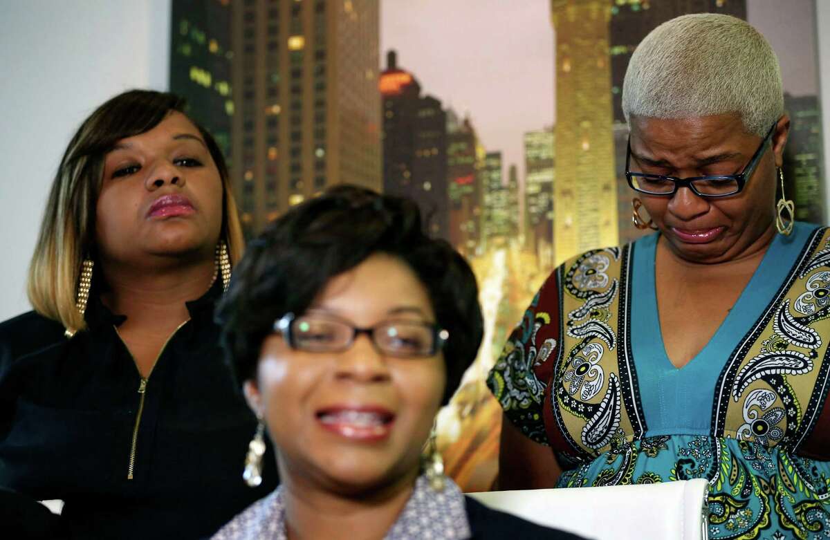 Sandra Bland's sisters Sharon Cooper, front, takes questions from the media, while her sisters Shavon Bland, left, and Shante Needham, become emotional, during a news conference about their sister's death Thursday, July 16, 2015 in Chicago. Sandra Bland, a 28-year-old woman who authorities say hanged herself in a Texas jail after her arrest for allegedly kicking an officer following a traffic stop gave no indication she was in such an emotional state that she would kill herself, her sister said Thursday. (Abel Uribe/Chicago Tribune via AP) MANDATORY CREDIT CHICAGO TRIBUNE; CHICAGO SUN-TIMES OUT; DAILY HERALD OUT; NORTHWEST HERALD OUT; THE HERALD-NEWS OUT; DAILY CHRONICLE OUT; THE TIMES OF NORTHWEST INDIANA OUT; TV OUT; MAGS OUT; NO SALES