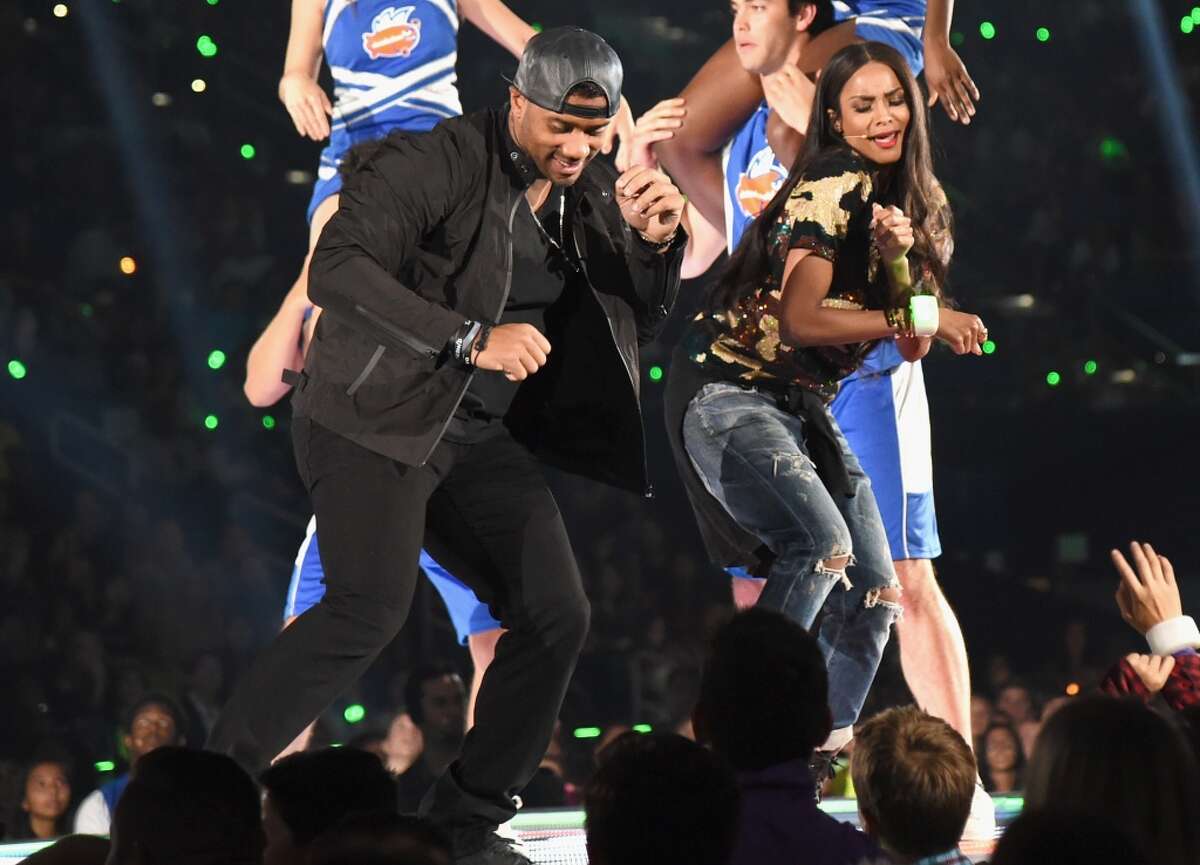 Seattle Seahawks quarterback Russell WIlson and Ciara dance onstage at the 2015 Nickelodeon Kids' Choice Sports Awards 2015 at UCLA's Pauley Pavilion on July 16, 2015 in Westwood,