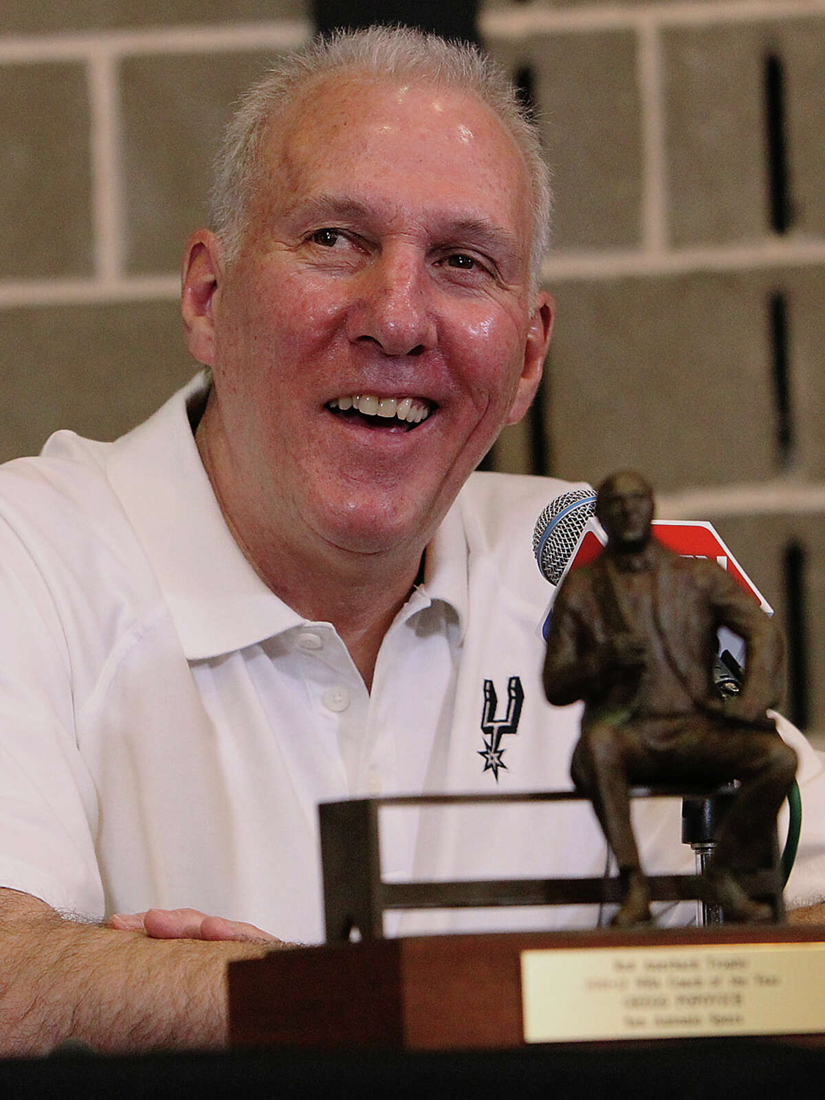 Spurs head coach Gregg Popovich with his Red Auerbach coach of the year trophy in 2012.