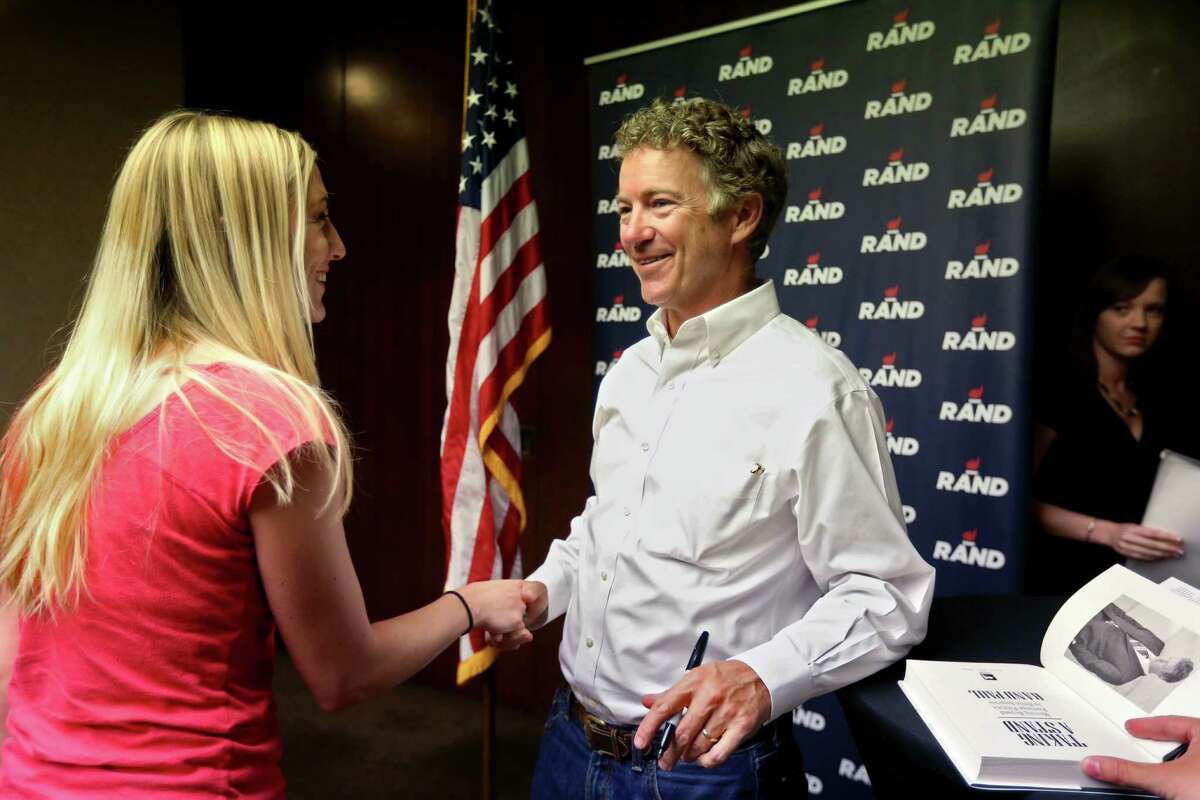 Republican presidential candidate Sen. Rand Paul greets a supporter at the Hyatt Regency in Houston.