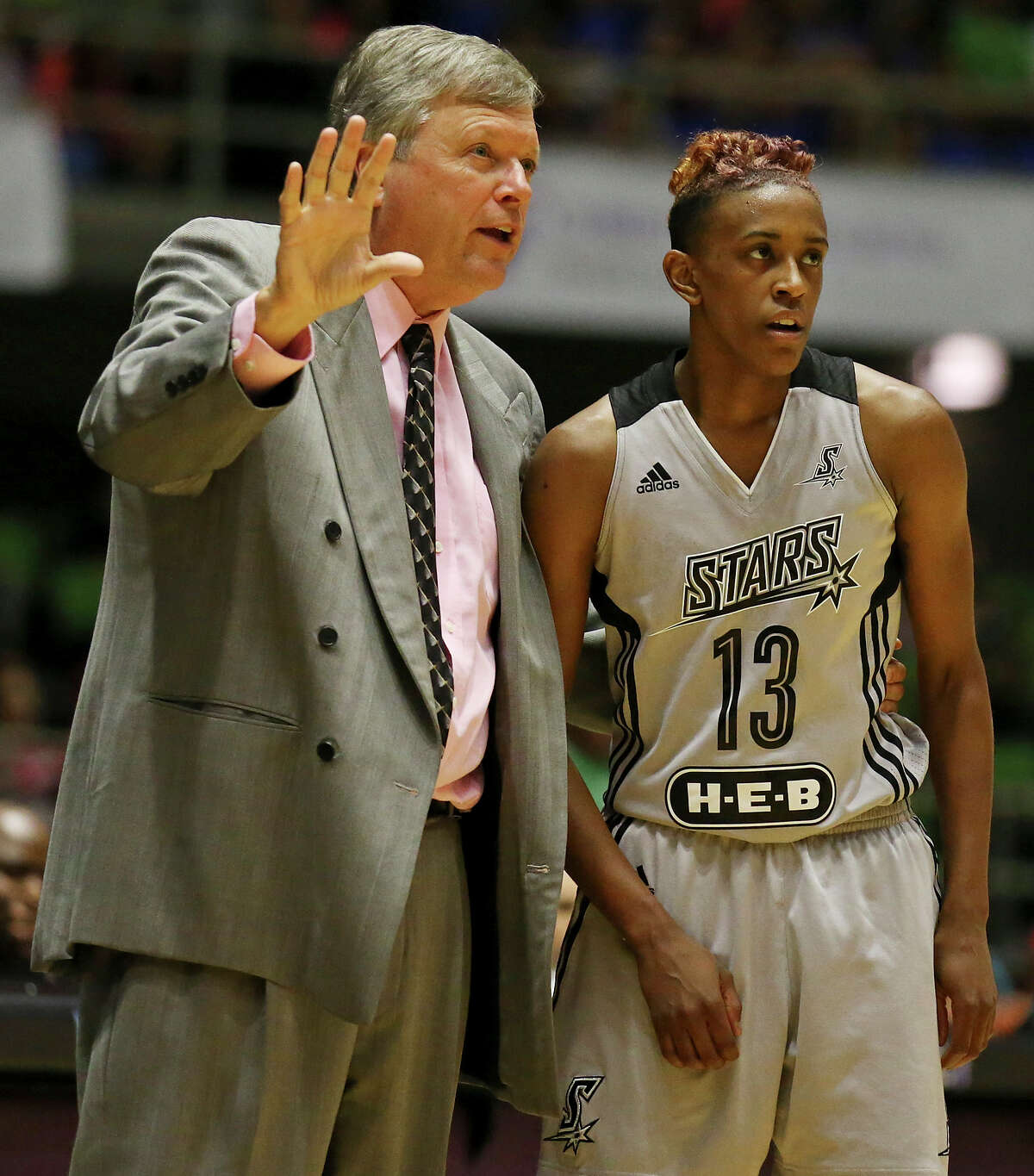 San Antonio Stars head coach Dan Hughes (left) talks with player Danielle Robinson during first half action against the Tulsa Shock Friday July 17, 2015 at the Freeman Coliseum.
