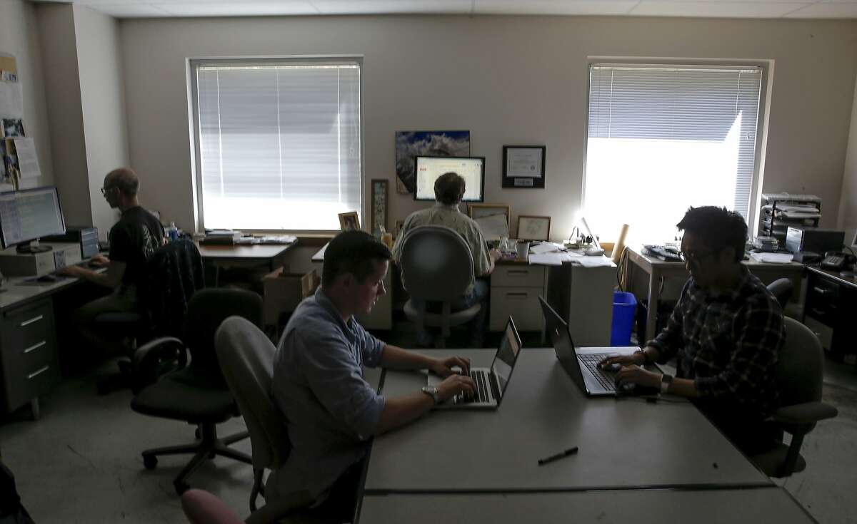 (l to r) Jeff Cobb, software engineer, UC Berkeley student Kyle Archer, studying mechanical engineering, Eric Korpela, the director of SETI (the Search for Extraterrestrial Intelligence) at Home and Kevin Luong, a UCLA student in computer science, are at work at the Berkeley SETI research center at UC Berkeley, on Fri. July 17, 2015, in Berkley, Calif.