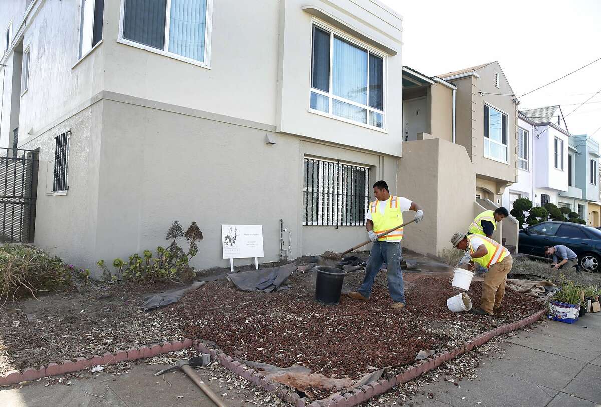 A landscaping crew tears up the front yard of a home on 41st Avenue and Moraga Street for a city sponsored redesign contest in San Francisco, Calif. on Saturday, July 18, 2015. Homeowners Wilson Ng and Neva Nguyen were declared the winners of a citywide contest to determine the ugliest front yard and received a new one designed with drought resistant native plantings.