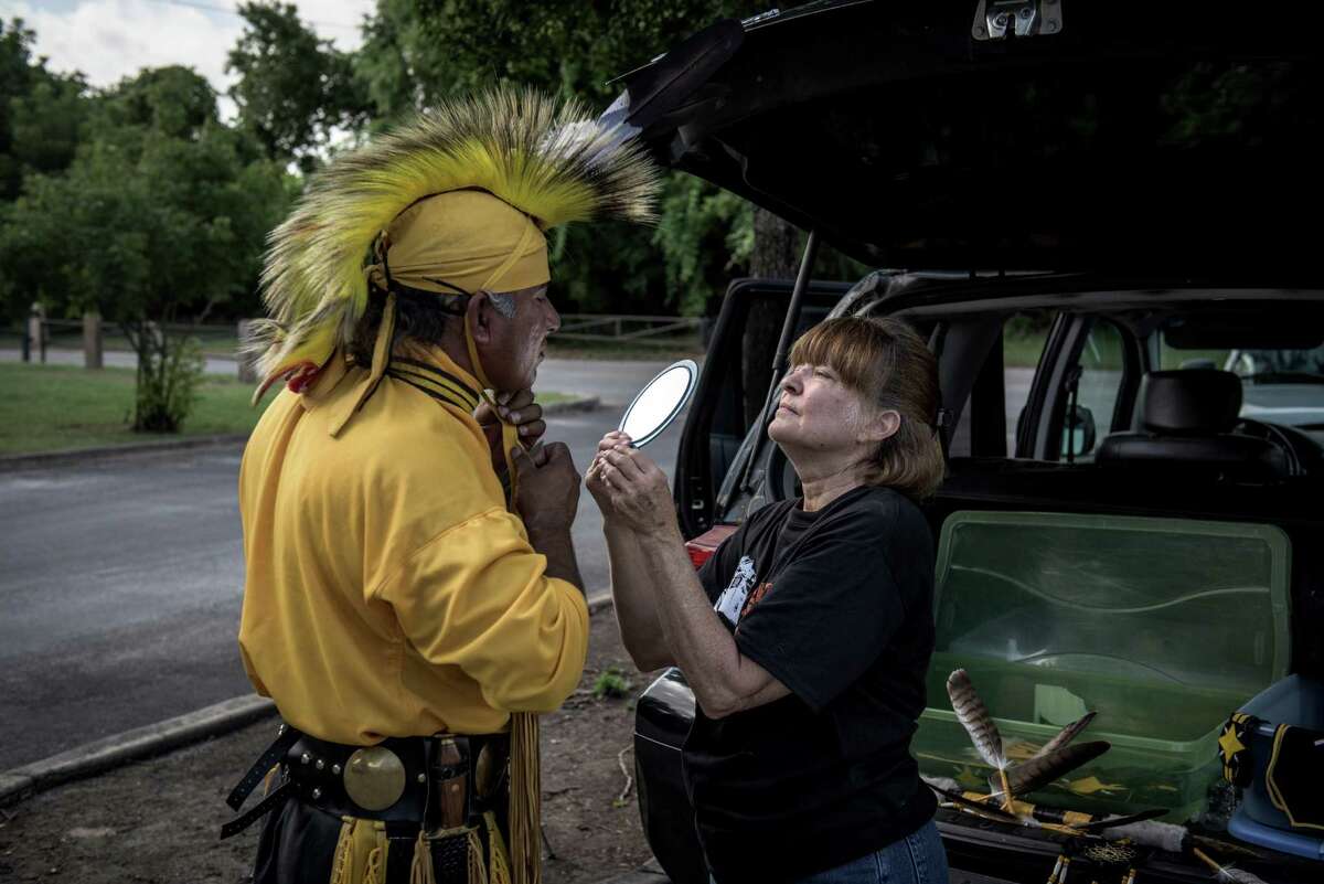 Tony Castaneda, a Lipan Apache, puts on his Native American outfit with the help of his wife, Dianna Fryer. The festival drew about 500 people, almost a record.