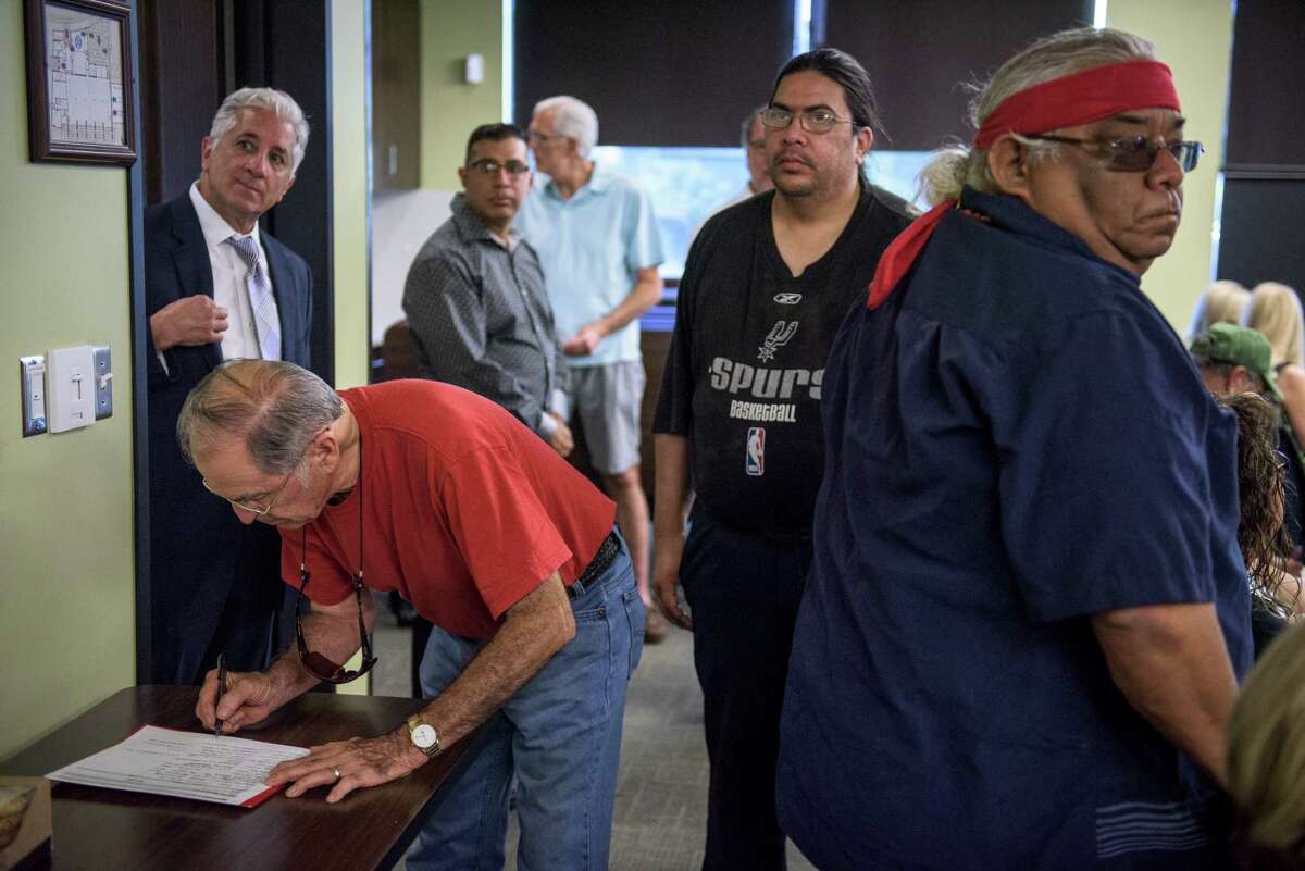 Residents sign in during a meeting between members of the Mission San Jose Neighborhood Association and San Antonio based developers 210 Development Group who want to build an apartment complex in proximity to San Jose Mission, which recently gained World Heritage Status.
