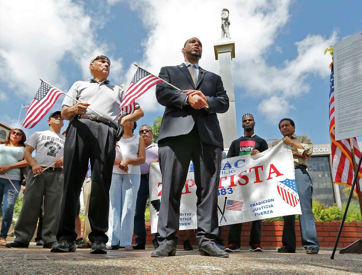 Bexar County 4th Precinct Commissioner Tommy Calvert (center), Mario Salas of San Antonio Coalition of Human and Civil Rights (left) and others gather for a press conference to demand the Confederate monument at Travis Park be removed in light of recent efforts by Bexar County officials to take down confederate symbols on public property. Since the park is on city property, the city council would have to vote and approve such a decision. Calvert and Salas hope to persuade their city officials to take such action. The monument has been at the park since 1899 which has a statue of a confederate soldier facing South and the words, "Our Confederate Dead" and "Lest we forget" engraved on the monument. (Kin Man Hui/San Antonio Express-News)
