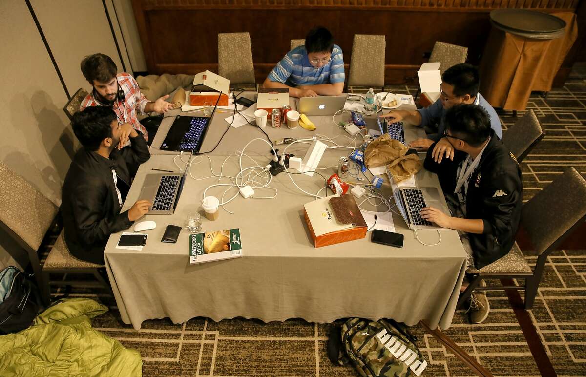 (far left) Jason Almeida and Sam Joseph work on their Project Bailey a political app during a Hackathon, while Shiyang Huang, (center) Wenliang Tong and Lei Chen design their app Donate & Save, where teams are creating business applications related to politics, taking place during a conference called Reboot. The conference focused on how to analyze and make inroads into the tech audience in the 2016 election, held at the Park Hotel in downtown San Francisco, Calif., on Sat. July 18, 2015.