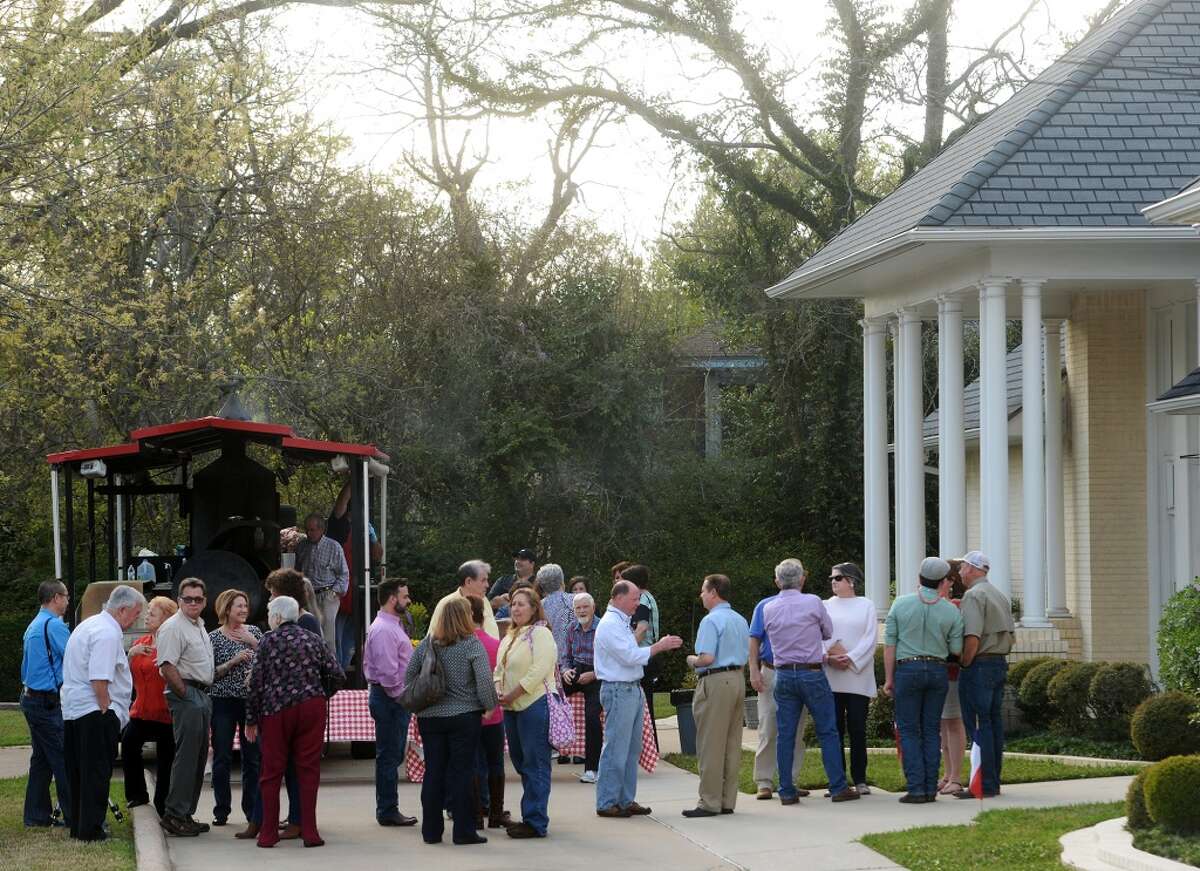 People line up outside the McFaddin-Ward House visitors center before Thursday's lecture on barbecue. Daniel Vaughn, barbecue editor for Texas Monthly, spoke Thursday afternoon at the McFaddin-Ward House about the history of Texas barbecue. Photo taken Thursday 3/19/15 Jake Daniels/The Enterprise