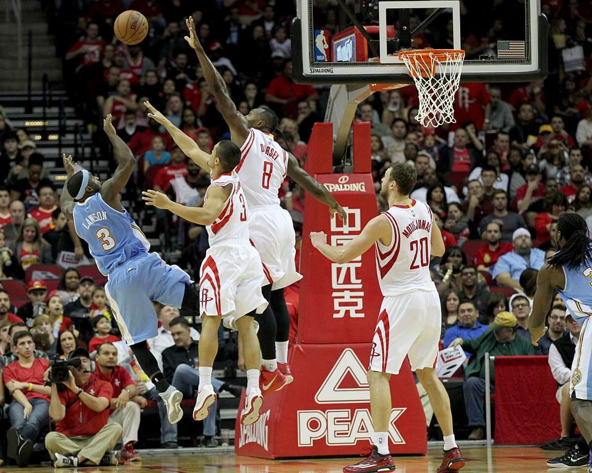 Houston Rockets guard Nick Johnson (3) and Houston Rockets forward Joey Dorsey (8) defend against Denver Nuggets guard Ty Lawson (3) shot in the second half at Toyota Center on Saturday, December 13, 2014 in Houston, TX. Rockets won 108 to 96. (Photo: Thomas B. Shea/For the Chronicle)
