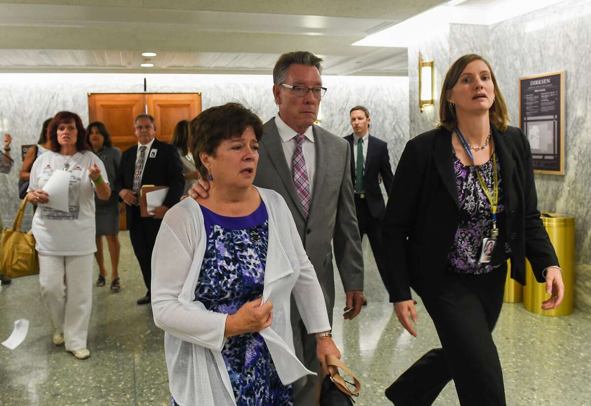 Liz Sullivan and Jim Steinle, parents of Kathryn Steinle, killed on a San Francisco Pier by a man previously deported several times, walk out after a Senate Judiciary hearing in Washington, Tuesday, July 21, 2015. The family told Congress they support changing the laws that allowed her alleged killer to remain in the United States despite being deported several times. (AP Photo/Molly Riley)