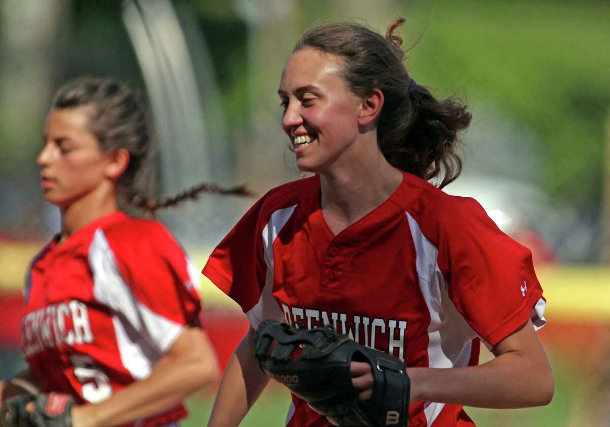 Cardinal outfield Colleen Bennett is all smiles following a shutout inning against south Windsor in Greenwich uin 2014. Bennett was named a National Merit Scholar.