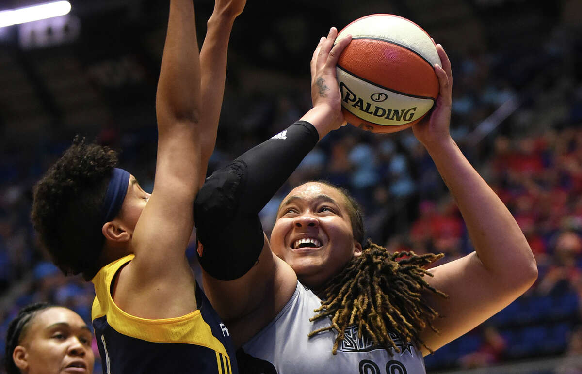 Danielle Adams of the San Antonio Stars shoots over Layshia Clarendon of the Indiana Fever during WNBA action at Freeman Coliseum on Tuesday, July 21, 2015.