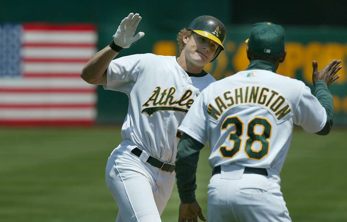 athletics103_mac.jpg A's 22- Eric Byrnes rounds 3rd base and gives a high-five to Ron Washington after a 3 run homer in the 4th inning. Oakland Athletics Vs. Texas Rangers.6/19/03 in Oakland. MICHAEL MACOR / The Chronicle