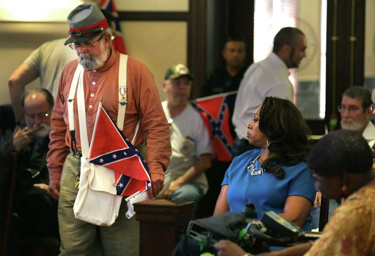 NAACP member Cassandra Littlejohn watches before Bill Manuel of the Sons of Confederate Veterans speaks.