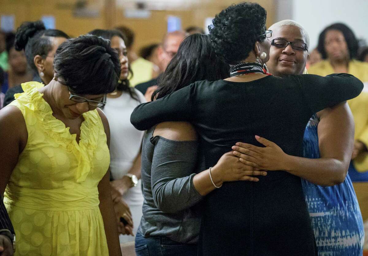 Geneva Reed-Veal, mother of Sandra Bland, embraces her daughter Shante Needham, right, during a memorial service Tuesday at Prairie View A&M.