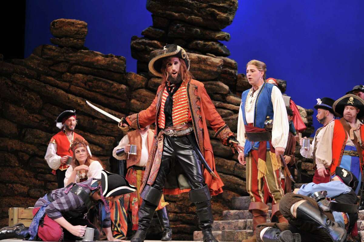 Dennis Arrowsmith, center, is the Pirate King, and Joshua LaForce, right foreground, is Frederic, in 'The Pirates of Penzance" at Wortham Theater Center.