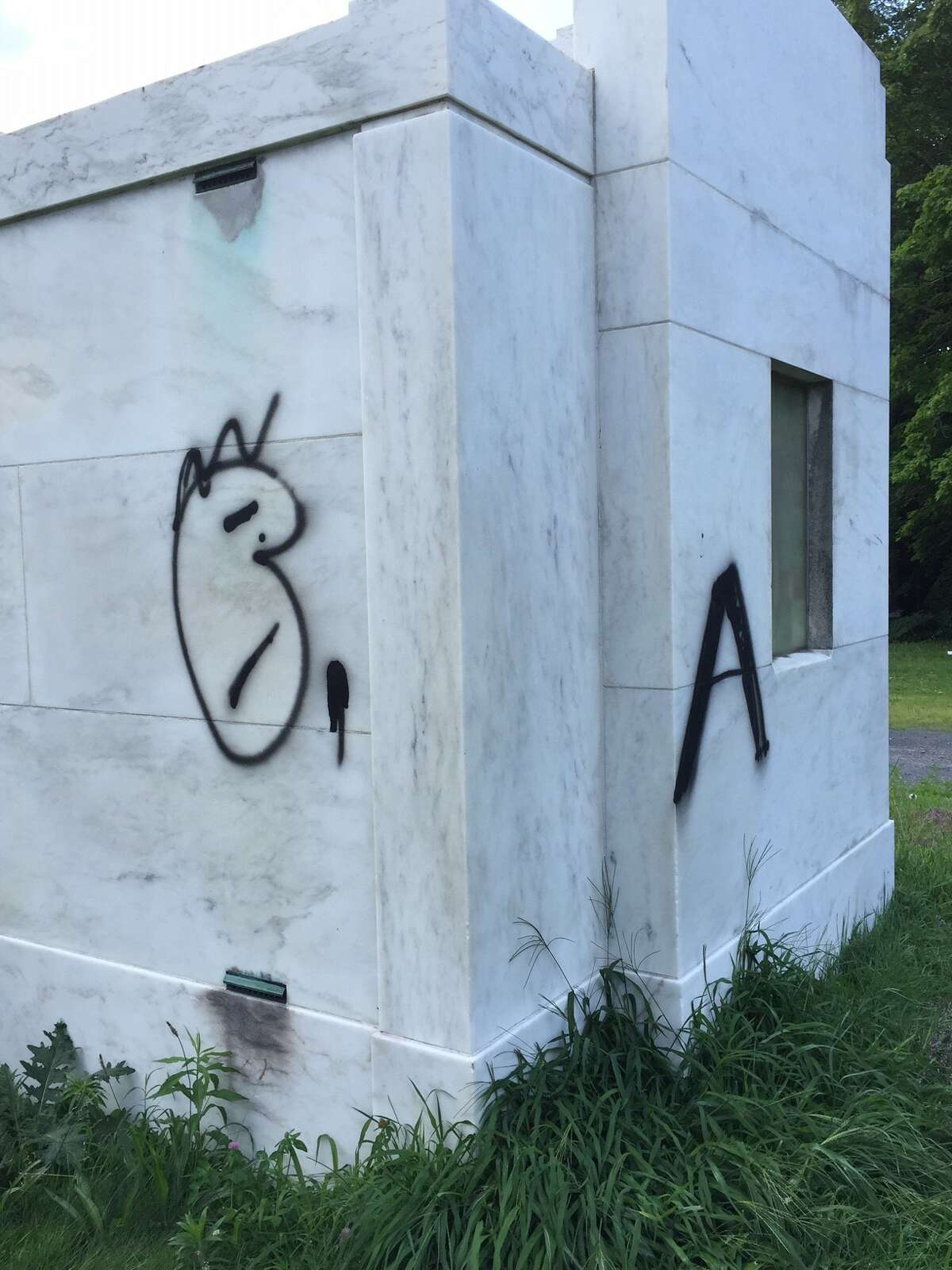 Vandals spray painted these graffiti tags on the Hosler mausoleum in Albany Rural Cemtery over the weekend and Colonie police are investigating, but they don't believe it is a hate crime or any way directed at the Hosler family, who owned Hosler Ice Cream Co. in Albany. (Paul Grondahl / Times Union)