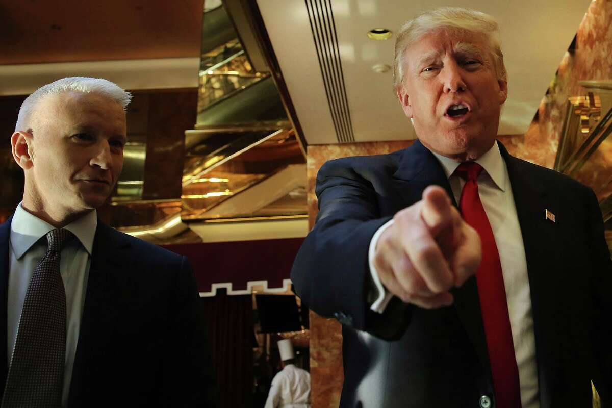 Donald Trump greets supporters, tourists and the curious after taping an interview with CNN’s Anderson Cooper at a Trump-owned building in midtown Manhattan on July 22, 2015. Trump, who is seeking the Republican nomination for president, has come under intensifying criticism for his behavior on the campaign trail. The billionaire's most recent comments on Senator John McCain's war record in Vietnam have resulted in almost universal criticism from fellow candidates.