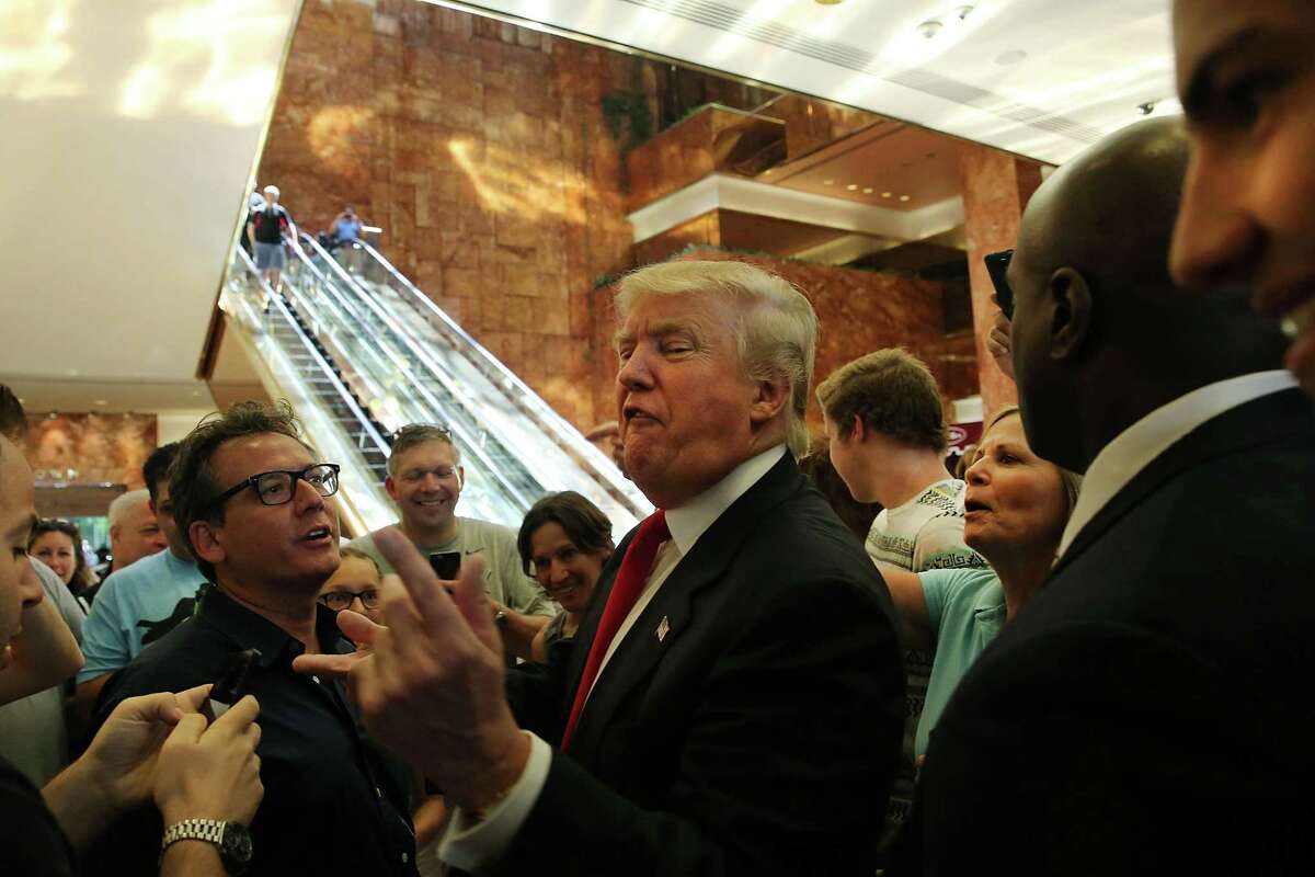 Donald Trump greets supporters, tourists and the curious after taping an interview with CNN’s Anderson Cooper at a Trump-owned building in midtown Manhattan on July 22, 2015. Trump, who is seeking the Republican nomination for president, has come under intensifying criticism for his behavior on the campaign trail. The billionaire's most recent comments on Senator John McCain's war record in Vietnam have resulted in almost universal criticism from fellow candidates.