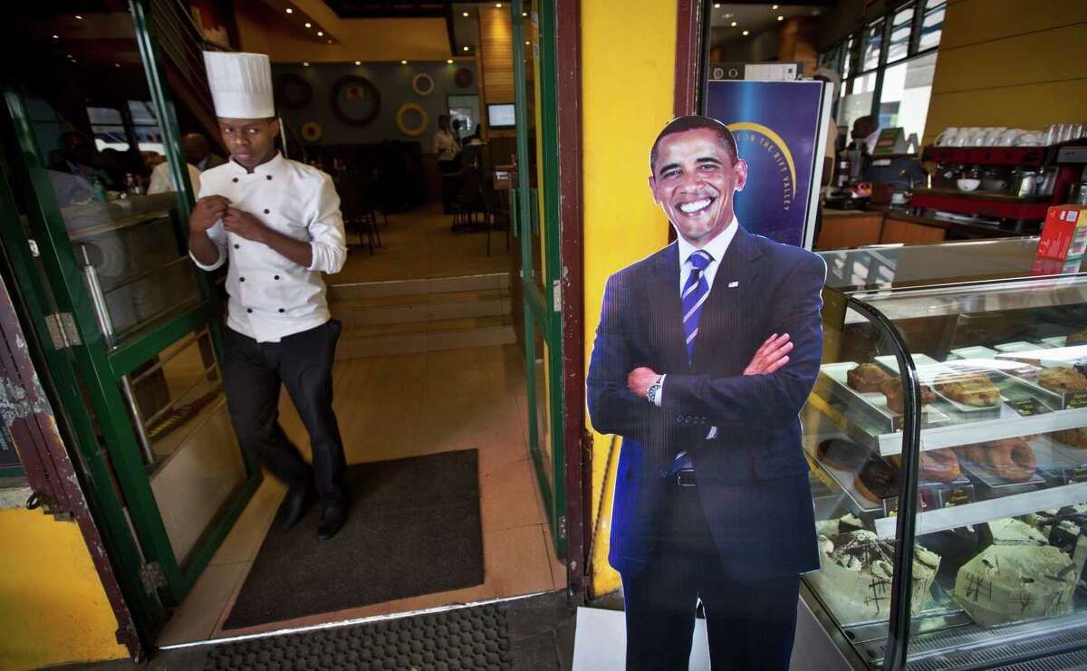 A chef walks past a cardboard cutout of President Barack Obama at the entrance to the Cafe Deli coffee shop in Nairobi, Kenya on Wednesday. Friday marks Obama's first trip to Kenya since 2006. Obama is scheduled to arrive in Kenya on Friday, the first stop on his two-nation African tour in which he will also visit Ethiopia. (AP Photo/Ben Curtis)