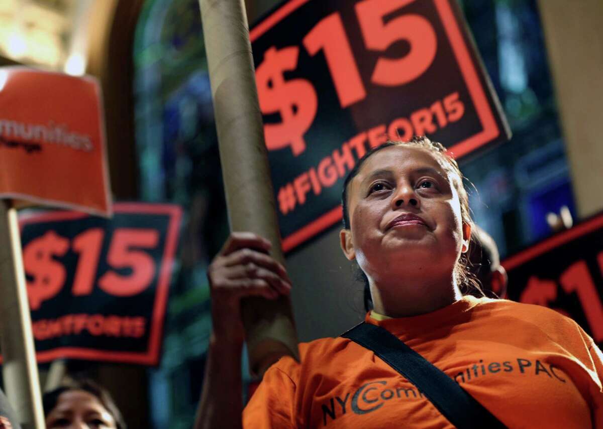 FILE - In this June 15, 2015, file photo, demonstrators rally for a $15 minimum wage before a meeting of the state Wage Board in New York. The New York state Wage Board is expected to recommend a higher minimum wage for the industry during a meeting, Wednesday, July 22, 2015, in New York City. Board members say they support an increase, though they havenât offered a specific amount. (AP Photo/Seth Wenig, File)