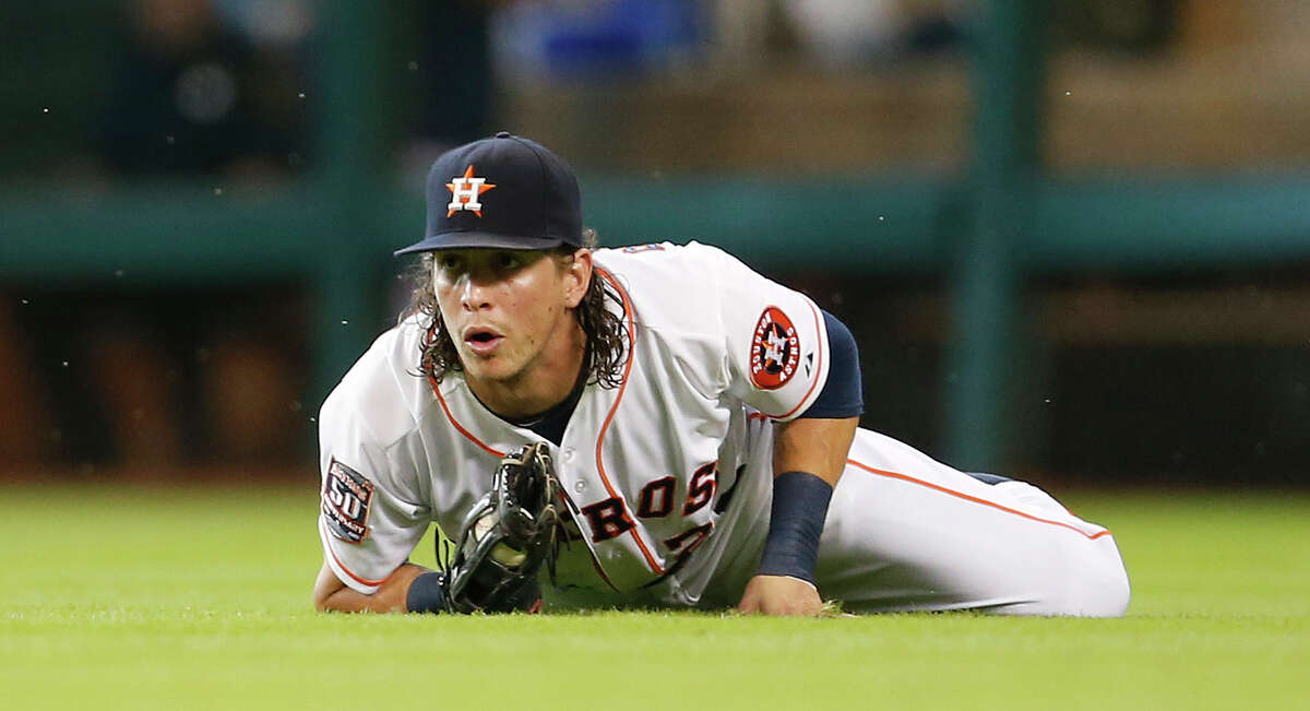 Astros right fielder Colby Rasmus comes up with a diving catch on a line drive hit by Red Sox center fielder Alejandro De Aza in the second inning Wednesday night.