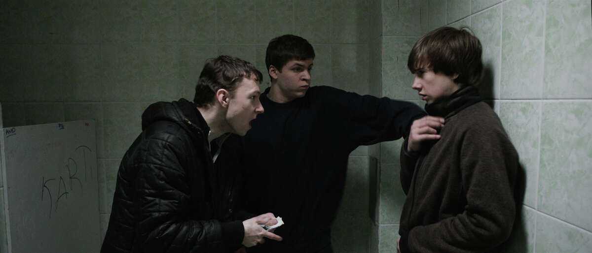 Sergey (Grigoriy Fesenko) and Shnyr (Alexandr Sidelnikov) threaten a younger schoolmate in Drafthouse FilmsÃ©­ The Tribe.