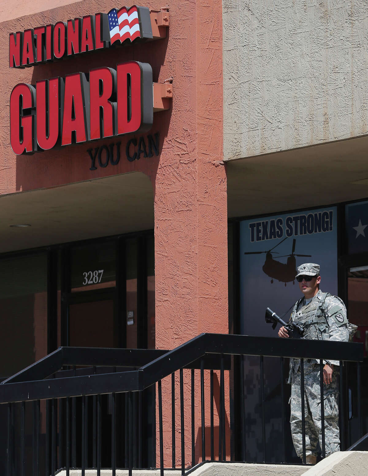 Armed Texas Army National Guardsmen are in front of recruiting office Thursday July 23, 2015 on the 3200 block of Wurzbach Road.