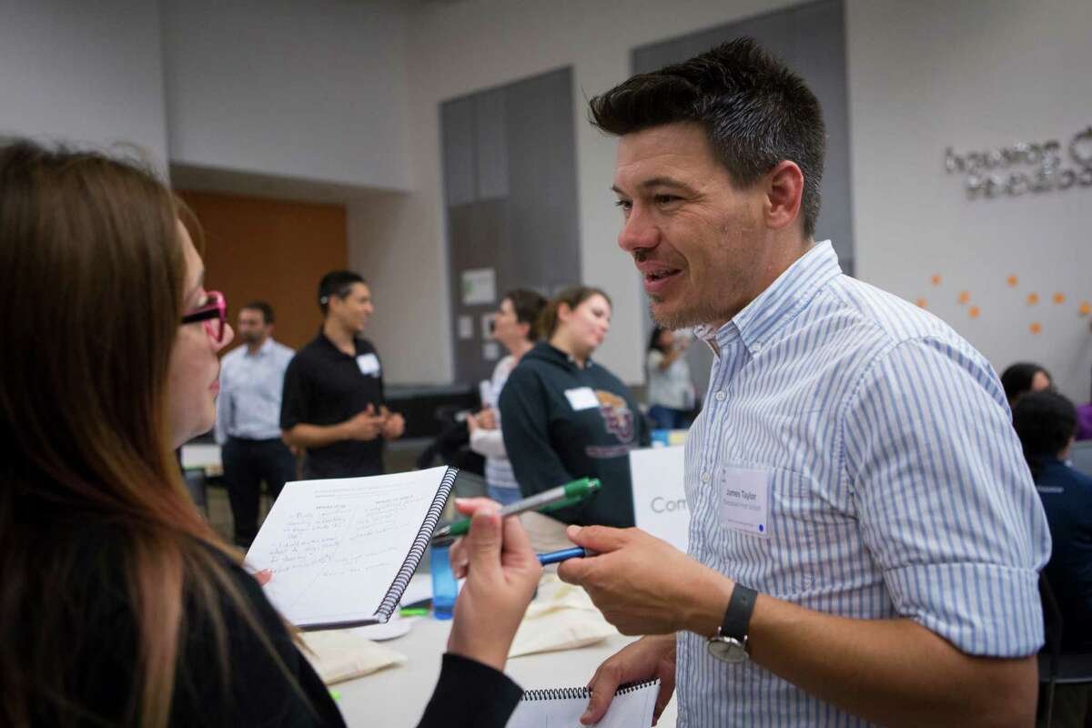 James Taylor, right, talks about empathy to Georgina Castilleja, left, during a workshop about the importance of of the skill on Wednesday in Houston. A workshop leader believes empathy is particularly important of educators and corporate executives to master.