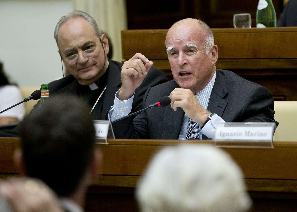 California Gov. Jerry Brown, right, delivers his speech flanked by the head of the pontifical academy of Science, Bishop Marcelo Sanchez Sorondo, during a conference on Modern Slavery and Climate Change in the Casina Pio IV the Vatican, Wednesday, July 22, 2015. Dozens of environmentally friendly mayors from around the world are meeting at the Vatican this week to bask in the star power of eco-Pope Francis and commit to reducing global warming and helping the urban poor deal with its effects. (AP Photo/Alessandra Tarantino)