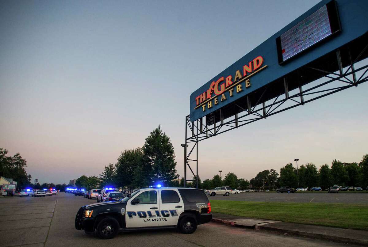 A Lafayette Police Department vehicle blocks an entrance at The Grand Theatre in Lafayette, La., following a shooting at the theater, Thursday, July 23, 2015. (Paul Kieu/The Daily Advertiser via AP)