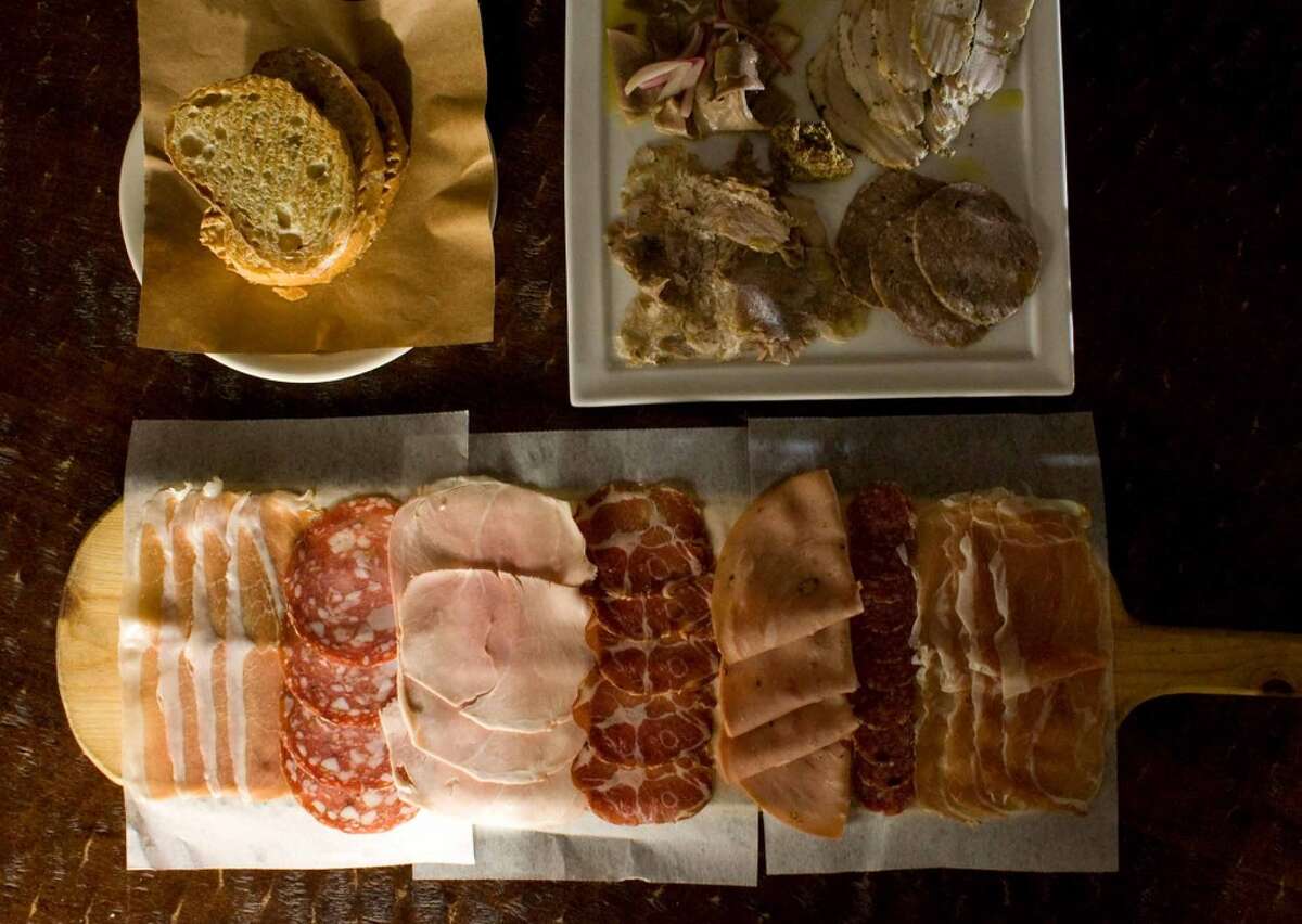 Salumi with house-made salumi testa, veal lingua, pork cheek sausage and porchetta as well as various other meats including prosciutto, spicy coppa and tuscan garlic salame at Vinoteca Poscol 
