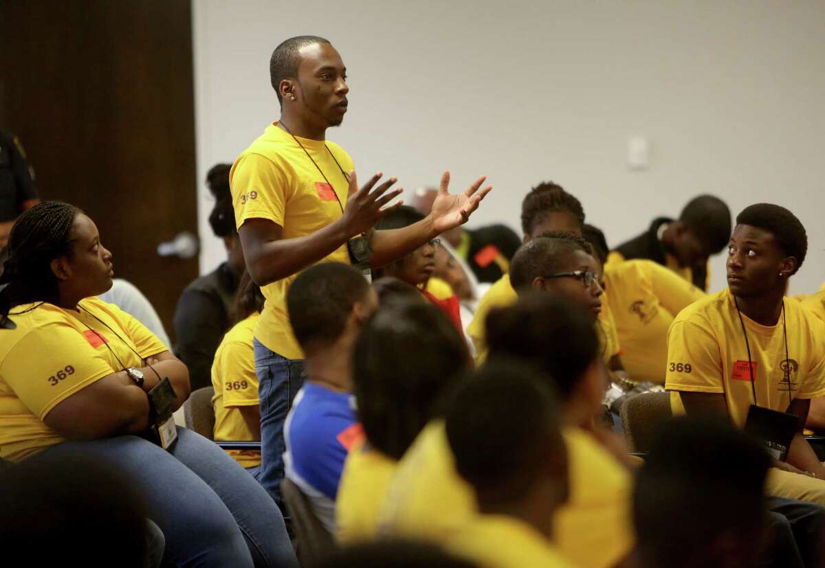 Ian Hawkins, an incoming freshman, taking part in Prairie View A&M University's Academy for Collegiate Excellence and Student Success - a program that provides intensive preparation and support for students who want to be successful in college, ask a question of Houston Chief of Police Charles McClelland while attending the Teen And Police Service Academy Youth and Police Summit at the Houston Police Department Friday, July 24, 2015, in Houston, Texas. Its purpose is to reduce the social distance and create better understanding between youth and law enforcement.